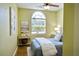 Light-filled bedroom with a large window, a ceiling fan, and tasteful decor, making it a cozy retreat at 6159 Fieldstone Cir, Charleston, SC 29414