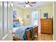 Bright bedroom with a ceiling fan, wooden furnishings, and soft blue accents create a relaxing atmosphere at 6159 Fieldstone Cir, Charleston, SC 29414