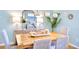 Inviting dining room boasts a stylish table, decorative lighting and coastal decor at 6159 Fieldstone Cir, Charleston, SC 29414