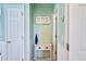 Hallway with white trim, white doors, pale blue walls, and a small accent table at 6159 Fieldstone Cir, Charleston, SC 29414