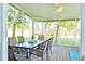 Spacious screened porch with ample seating and backyard views at 6159 Fieldstone Cir, Charleston, SC 29414