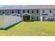 View of the backyard with a manicured lawn, privacy fence, and covered patio on the back of the townhome at 715 Hilchot Dr, Summerville, SC 29486
