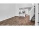 Bright open living room with hardwood floors connects the kitchen and stairway at 715 Hilchot Dr, Summerville, SC 29486