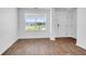 Light filled room boasting wood-look flooring, a view of the private lawn and a white painted door at 715 Hilchot Dr, Summerville, SC 29486