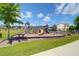 Community playground with multiple play structures, climbing walls, and picnic benches on a sunny day at 715 Hilchot Dr, Summerville, SC 29486