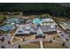 An aerial view of the community clubhouse and pool area with tennis courts and parking at 754 Blue Iris Way, Summerville, SC 29486