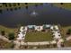 A serene aerial view of a waterfront amenity area with a fountain, fire pit, and seating at 754 Blue Iris Way, Summerville, SC 29486