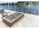 View of the community patio and outdoor fireplace overlooking the lake with fountain feature at 754 Blue Iris Way, Summerville, SC 29486