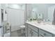 Light and bright bathroom with a white vanity, shower curtain, and glass display shelf at 754 Blue Iris Way, Summerville, SC 29486