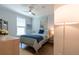 Bedroom with coastal style, light wood floors, ceiling fan, and a view of the neighborhood at 754 Blue Iris Way, Summerville, SC 29486