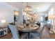 Bright dining area featuring a chandelier and view of the open-concept kitchen with stainless steel appliances at 754 Blue Iris Way, Summerville, SC 29486