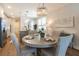 Charming dining room features a stylish chandelier and complements the open-concept kitchen at 754 Blue Iris Way, Summerville, SC 29486