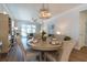 Elegant dining area with chandelier open to living area and kitchen at 754 Blue Iris Way, Summerville, SC 29486