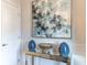 Charming entryway with stylish mirror table, decor and views of the doors to other rooms at 754 Blue Iris Way, Summerville, SC 29486
