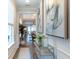 Welcoming entryway showcasing neutral walls, wood floors, modern console table and a glimpse into living spaces at 754 Blue Iris Way, Summerville, SC 29486