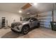 Spacious garage featuring a parked car and ample room for storage, with an automatic door opener at 754 Blue Iris Way, Summerville, SC 29486
