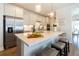 Bright kitchen featuring white cabinets, stainless steel appliances, pendant lighting, and a large island at 754 Blue Iris Way, Summerville, SC 29486