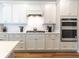 Elegant kitchen with modern appliances, sleek white cabinets, and subway tile backsplash at 754 Blue Iris Way, Summerville, SC 29486