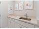 Functional laundry area featuring a sleek sink, ample countertop, and stylish decorations on the wall at 754 Blue Iris Way, Summerville, SC 29486