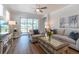 Cozy living room with stylish decor, comfortable sofa, and a view of the screened porch at 754 Blue Iris Way, Summerville, SC 29486