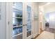 Office with glass desk and french doors, view into a bright ensuite bedroom and bath at 754 Blue Iris Way, Summerville, SC 29486