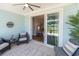Inviting patio with comfortable seating, ceiling fan, and a view to interior through sliding glass door at 754 Blue Iris Way, Summerville, SC 29486