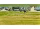 A group of geese grazes near the pond, reflecting the clear sky and serene surroundings at 754 Blue Iris Way, Summerville, SC 29486