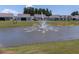 Scenic view of the community pond with a water fountain, surrounded by well-manicured lawns at 754 Blue Iris Way, Summerville, SC 29486