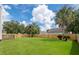 Large backyard featuring a beautiful lawn, privacy fence, and mature palm trees at 7812 Spring Creek Rd, North Charleston, SC 29418