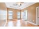 Spacious bedroom with a tray ceiling, hardwood floors, and two windows for natural light at 7812 Spring Creek Rd, North Charleston, SC 29418