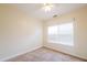 Simple bedroom with carpet, ceiling fan, and a window for natural light at 7812 Spring Creek Rd, North Charleston, SC 29418