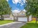 Inviting exterior of home with a two-car garage, brick accents, and well-maintained lawn at 7812 Spring Creek Rd, North Charleston, SC 29418