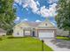 Beautifully maintained home featuring a well-kept lawn, a two-car garage, and tasteful landscaping at 7812 Spring Creek Rd, North Charleston, SC 29418