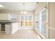 Bright kitchen with tile floor, white cabinetry, stainless appliances and breakfast bar at 7812 Spring Creek Rd, North Charleston, SC 29418