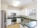 Bright kitchen features white cabinets, stainless steel appliances, and a window over the sink at 7812 Spring Creek Rd, North Charleston, SC 29418