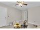 Bedroom with tan carpet and ceiling fan is undergoing renovation, featuring painting supplies at 9009 Cat Tail Pond Rd, Summerville, SC 29485