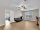 Bonus room with ceiling fan, wood floors, view into another room, small couch and a window at 9009 Cat Tail Pond Rd, Summerville, SC 29485
