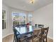 Dining area features a spacious table for six, natural light, and views of the surrounding neighborhood at 9009 Cat Tail Pond Rd, Summerville, SC 29485