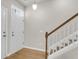 Bright foyer featuring wood-look floors, white wainscoting and staircase leading to the upper level at 9009 Cat Tail Pond Rd, Summerville, SC 29485