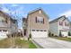 Inviting two-story home with a two-car garage, red front door, and professionally landscaped yard at 9009 Cat Tail Pond Rd, Summerville, SC 29485