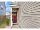 Charming covered entryway with a red front door adorned with a decorative wreath at 9009 Cat Tail Pond Rd, Summerville, SC 29485