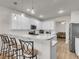 Beautiful kitchen includes modern light fixtures, quartz countertops, and stainless appliances, with bar stool seating at 9009 Cat Tail Pond Rd, Summerville, SC 29485