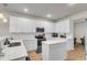 Modern kitchen featuring a center island with quartz countertops, stainless steel appliances and ample cabinet space at 9009 Cat Tail Pond Rd, Summerville, SC 29485