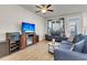 Comfortable living room with ceiling fan, large TV, and plush seating for relaxing and watching television at 9009 Cat Tail Pond Rd, Summerville, SC 29485