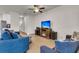 Inviting living room features a ceiling fan and entertainment center with a built-in fireplace at 9009 Cat Tail Pond Rd, Summerville, SC 29485