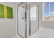 Modern shower stall with glass doors and white tiled walls, situated beside a window at 9009 Cat Tail Pond Rd, Summerville, SC 29485