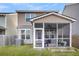Outdoor sunroom features screened walls, ceiling fan, furniture, and outdoor cooking equipment at 9009 Cat Tail Pond Rd, Summerville, SC 29485