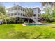 Spacious backyard with a pool and manicured lawn, perfect for entertaining guests and enjoying outdoor living at 932 Middle St, Sullivans Island, SC 29482