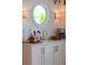 Wet bar area featuring a round window, a sink, designer lights and under-cabinet lighting at 932 Middle St, Sullivans Island, SC 29482