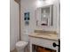 Compact bathroom featuring neutral color palette, granite countertop, and a tiled shower behind a curtain at 932 Middle St, Sullivans Island, SC 29482